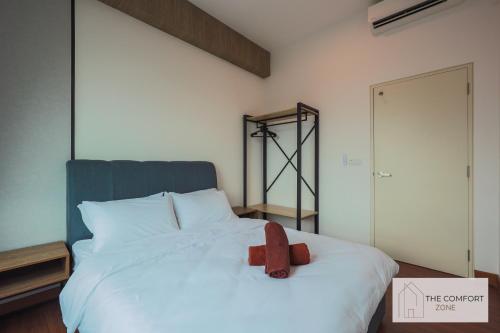 a bed with a teddy bear sitting on top of it at Greenfield Residence, Bandar Sunway by The Comfort Zone in Petaling Jaya