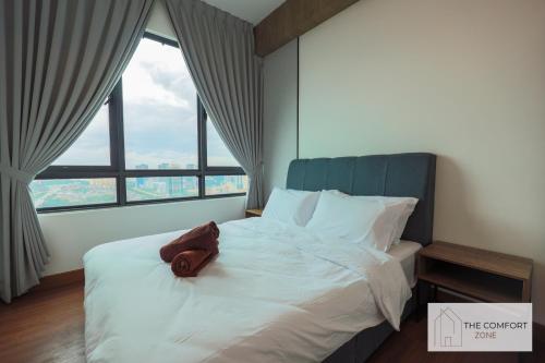 a bed in a room with a large window at Greenfield Residence, Bandar Sunway by The Comfort Zone in Petaling Jaya