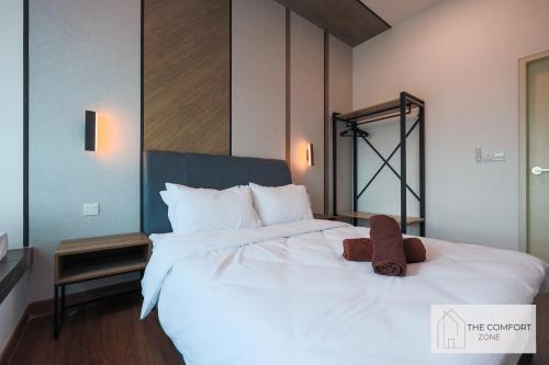 a large white bed with a teddy bear sitting on it at Greenfield Residence, Bandar Sunway by The Comfort Zone in Petaling Jaya