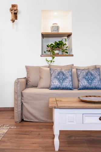 a living room with a couch and a table at Green Mountain Seaview Suite in Achílleion