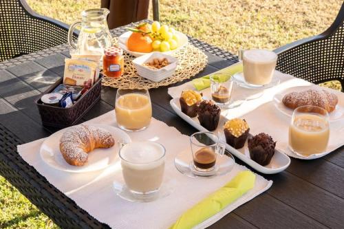 a table with plates of food and glasses of milk at Laurus Cilento Relax BeB in Laureana Cilento