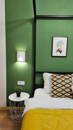 a green bedroom with a bed and a green wall at Best Apartments on Kyryla & Mefodia in Mukacheve