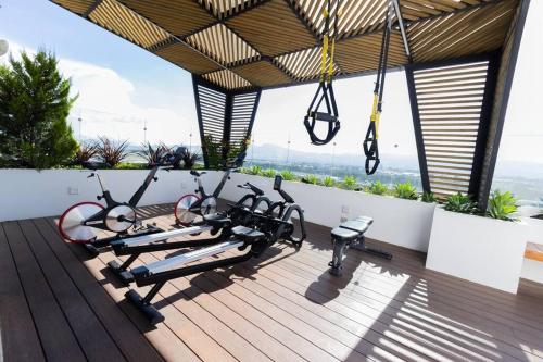 a fitness room with a gym on a roof at Amazing Volcano Views in front of airport in Guatemala