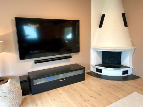 a living room with a large flat screen tv at Central family twinhouse in Stavanger