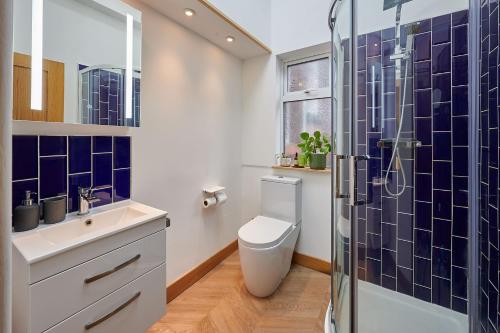 a bathroom with a toilet and a glass shower at Host & Stay - 19 Garswood in Liverpool