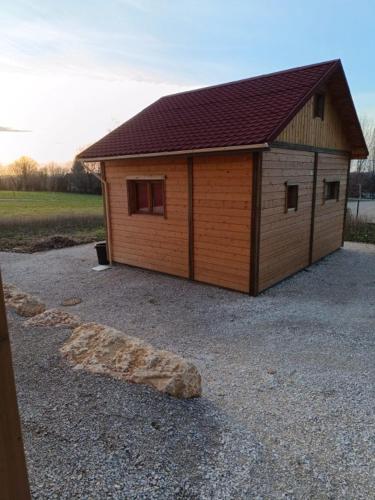 a small wooden building with a roof at La p'tite maison bois du hérisson in Ménétrux-en-Joux