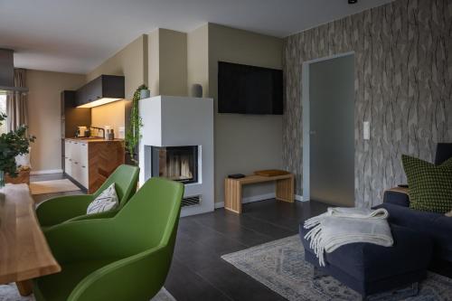 a living room with a couch and a fireplace at Deine Genuss-Auszeit in Asendorf