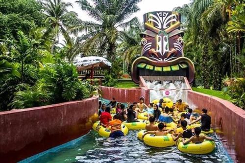 a group of people riding on tubes in a water park at Casa Savoy - A Famosa Resort Melaka in Kampong Alor Gajah