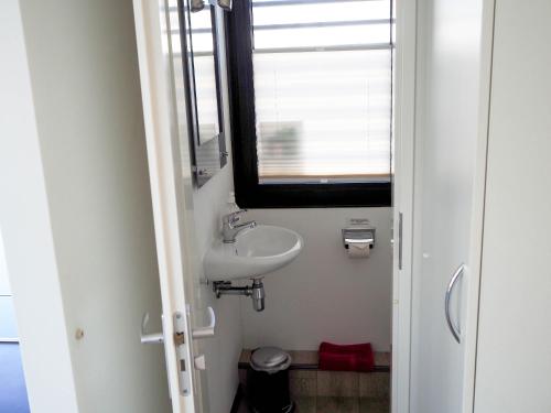 a small bathroom with a sink and a window at Ostsee Hausboot Boltenhagen - WELL Hausboote LP4 in Boltenhagen