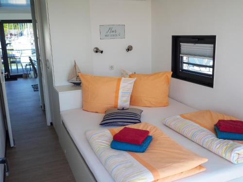 a room with two pillows on a white couch at Ostsee Hausboot Boltenhagen - WELL Hausboote LP4 in Boltenhagen
