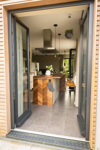 a kitchen with a counter and a large glass window at Deine Genuss-Auszeit in Asendorf