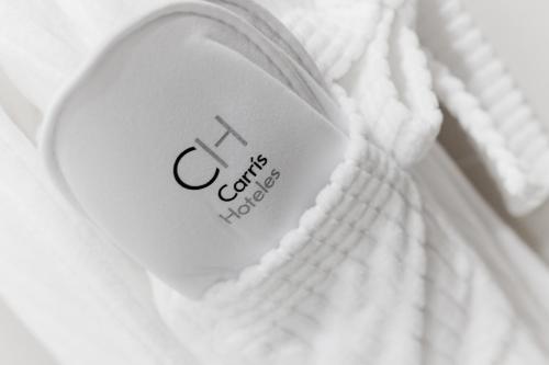 a close up of a heart on a white blanket at Hotel Carris Marineda in A Coruña