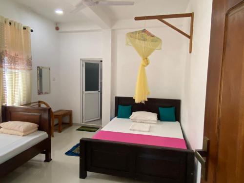 a bedroom with two beds in a room at KANDULA - Infrant Of the National Park - in Udawalawe