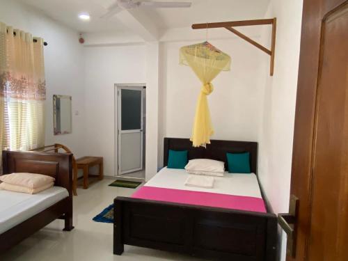 a bedroom with two beds in a room at Wild Bee Safari Lodge in Udawalawe