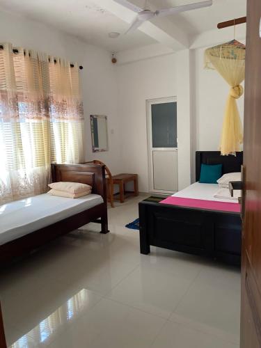 a bedroom with two beds and a tub in it at Wild Bee Safari Lodge in Udawalawe