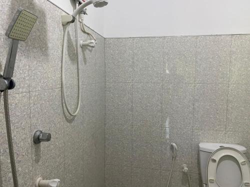 a bathroom with a shower and a toilet at Wild Bee Safari Lodge in Udawalawe