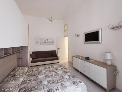 una camera con letto e divano di La Pescheria Casa Vacanze a Gaeta