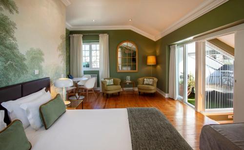 a bedroom with a bed and a living room at Casa Vela Boutique House in Cascais
