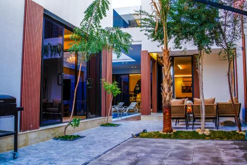 a courtyard with trees in front of a building at The land Resort in Riyadh