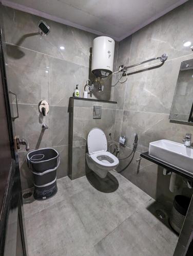 a bathroom with a toilet and a sink at Himalayan Hideaway in Shimla