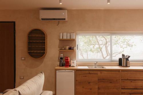 a kitchen with a sink and a window at Garden by Holistay in Tirana