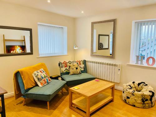 a living room with a couch and a table at Our Happy Place- 2 bedroom apartment with designated parking - Brixham in Brixham