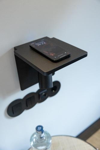 a black table with a cell phone on top of it at Axis Porto Club Aliados in Porto
