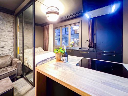 a kitchen with a sink and a bed in a room at * FASHIONABlE * CENTRAl * KING BED * STYLISH * in Oslo