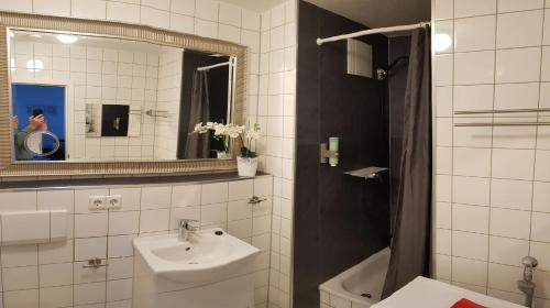 a white bathroom with a sink and a mirror at FeWo 2,4,5,6 Altstadt - Am grossen Garten in Dresden