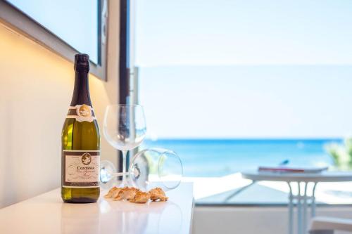 a bottle of wine sitting on a table next to a glass at Lido Star in Faliraki