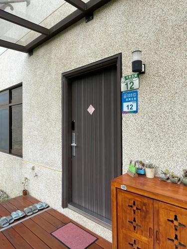a door to a building with a sign on it at 飲山風民宿 in Jian
