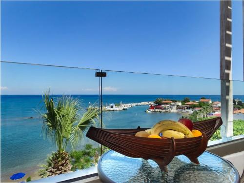 a bowl of fruit on a glass table in front of a window at Lido Star in Faliraki