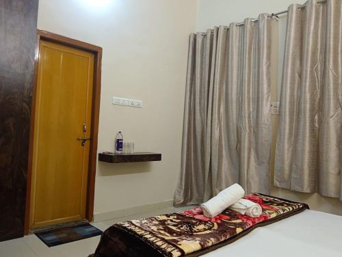 a room with a bed with a door and curtains at Happy Homes in Varanasi