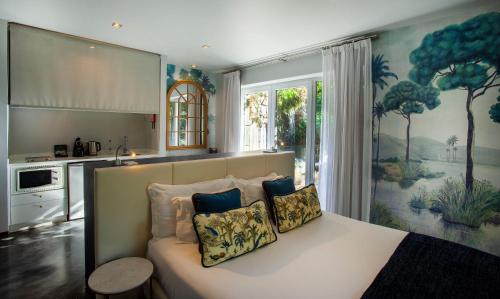 a bedroom with a bed with two pillows on it at Casa Vela Boutique House in Cascais