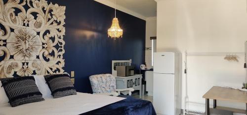 a bedroom with a bed and a refrigerator at Grazia Overnight accommodation in Harrismith