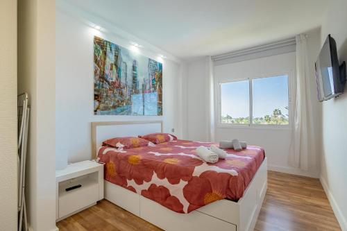 a white bedroom with a bed with a cow blanket at Luxury Loft en Maspalomas con Terraza y Piscina in Maspalomas