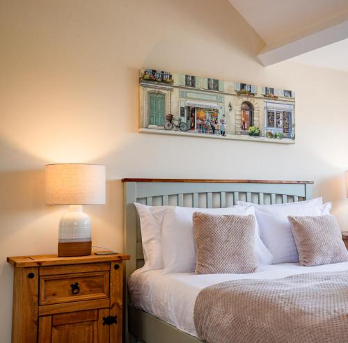 a bedroom with a bed and a lamp on a night stand at Newly refurbished apartment in city centre in Hereford