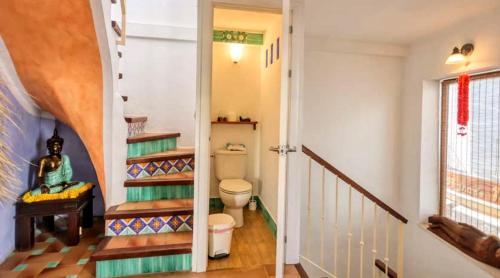 a hallway with a toilet and stairs in a house at La Plaza de Conil in Conil de la Frontera