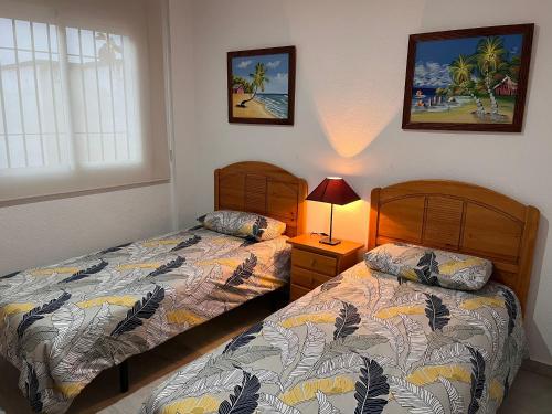 dos camas sentadas una al lado de la otra en un dormitorio en ALFAROS HOME, en Córdoba