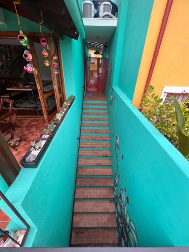 a stairway leading up to a blue building at Pousada Bat N Breakfast No Beco do Batman in Sao Paulo
