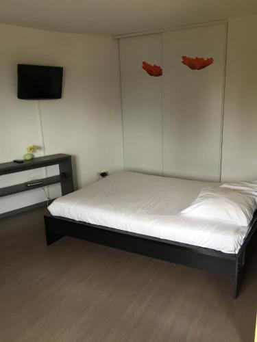 a bedroom with a bed with red masks on the wall at La Résidence Amal in Talence