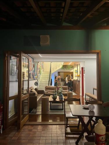 a living room with a couch and a table at Pousada Bat N Breakfast No Beco do Batman in Sao Paulo