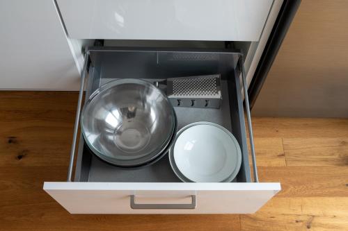 a metal bowl in a drawer of an appliance at Wohlfühl Lodge in Saarburg