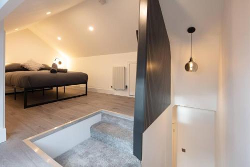 a bedroom with a bed and a tub in a room at Cosy 1 Bed Duplex - Close to Metro - NW2 in London