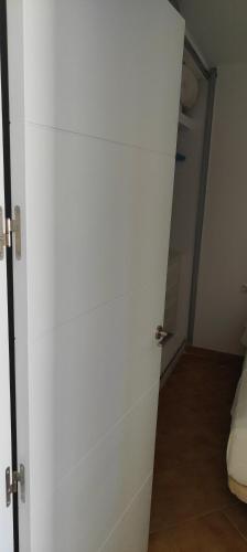 a white door in a room with a hallway at ATICOS Primera Linea en ZAHARA DE LOS ATUNES in Zahara de los Atunes