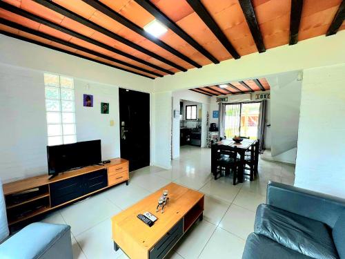 a living room with a couch and a table at Casa piscina Atlantida in Atlántida