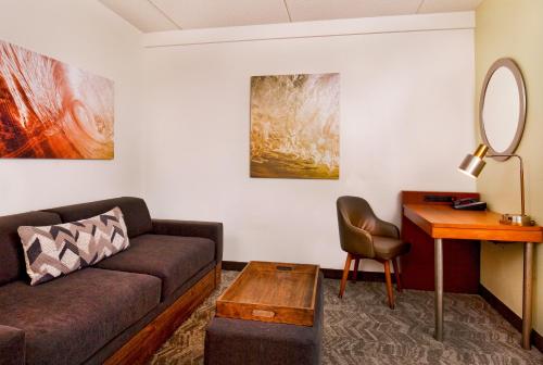 a living room with a couch and a table at SpringHill Suites Chesapeake Greenbrier in Chesapeake