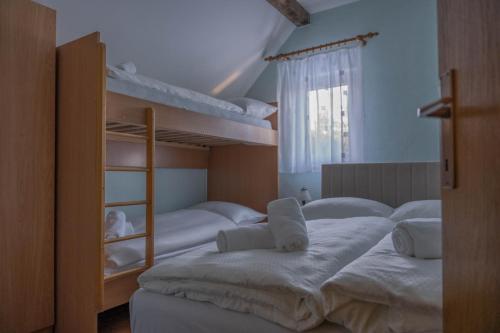a bedroom with three bunk beds and a window at Mountain House Skimont, Blidinje in Blidinje