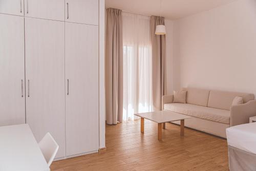 a white living room with a couch and a table at Residence Altair - Serra degli Alimini in Otranto