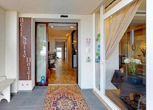 a hallway of a building with a door and a rug at Bell Suite Hotel in Bellaria-Igea Marina